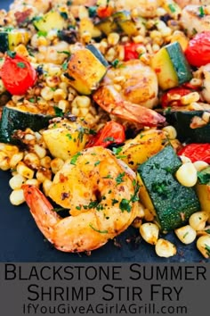 grilled shrimp, corn and vegetables on a black plate with text overlay that reads blackstone summer shrimp stir fry