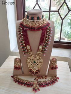 an elaborate necklace and earring set on display