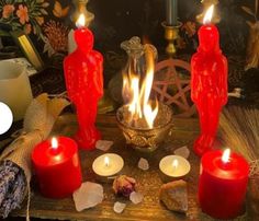 candles are lit on a table with other items