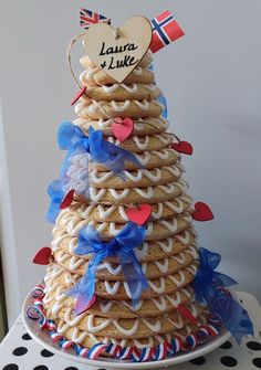 a cake made to look like a stack of cookies with flags and hearts on top