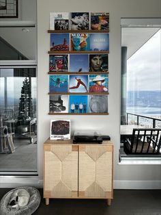 a living room with pictures on the wall and an entertainment center in front of it