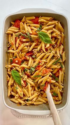 pasta with tomatoes and basil in a casserole dish