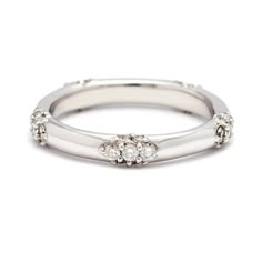 a white gold ring with three diamonds