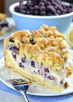 a slice of blueberry crumb cake on a plate with a fork next to it