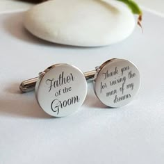 two cufflinks with the words father of the groom and thank you for raising the man of my dreams