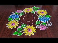 a wooden table topped with an artisticly painted flower design