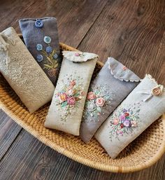 four different colored linens in a wicker basket