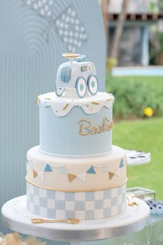 a blue and white cake sitting on top of a table