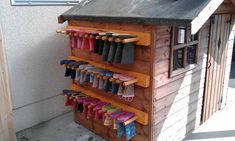 an outdoor storage shed with umbrellas and shoes on it