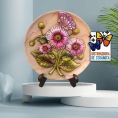 a ceramic plate with pink flowers and butterflies on it