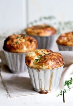 three muffins sitting on top of a white table