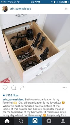 an open drawer with many cords and plugs in it, on top of a white tiled floor