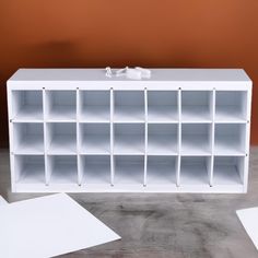 a white shelf with several compartments on it