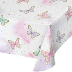 a table cloth with pink and blue butterflies on it's side, in front of a white background