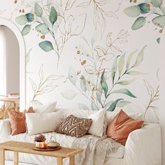 a living room with a couch, coffee table and wall mural