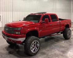 a red pickup truck parked in a garage