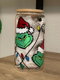 there is a glass jar with the grin face on it