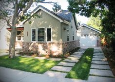 a house with grass and trees in the front yard