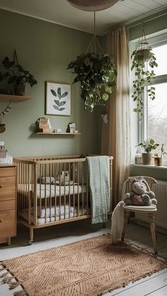 a baby's room with a crib, rocking chair and potted plants