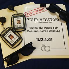 a wedding card, sunglasses and ring on top of a piece of paper that says your mission guard the rings for mom and joey's wedding