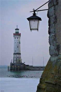 a light house sitting on top of a cliff next to the ocean