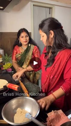 two women are preparing food in a kitchen