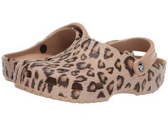 Crocs Classic Animal Print Clog - Shoes : Leopard/Gold : Crocs comfort Iconic Level 1. You will be wildly comfortable in the posh Crocs Classic Animal Print Clog. Thermoplastic (EVA) foam construction makes them incredibly light. Easy slip-on with adjustable back strap. Extra roomy for a comfortable fit. Ventilation system that allows air and water to pass through multiple ports inside of shoe. Iconic Crocs Comfort: original foam cushioned footbed. Thermoplastic (EVA) outsole. Imported. Measurem Cheetah Print Crocs, Cheetah Crocs, Leopard Crocs, Crocs Fashion, Crocs Clogs, Embroidered Shoes, Shoe Size Conversion, Clogs Shoes, Shoe Size Chart