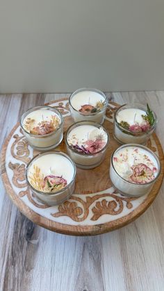 six bowls filled with food sitting on top of a wooden tray