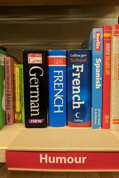 books are lined up on a shelf in a library, with the word humour written below them