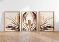 three framed art pieces on the wall in an empty room with hard wood flooring