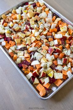 a pan filled with chopped vegetables on top of a wooden table