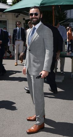 a man in a suit and tie standing on the street