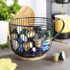 a metal basket filled with different types of condiments on top of a counter