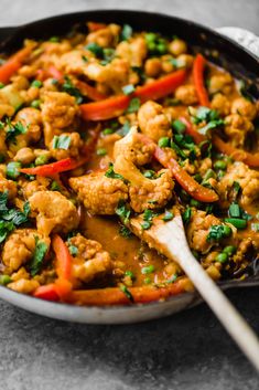 a skillet filled with chicken and vegetables