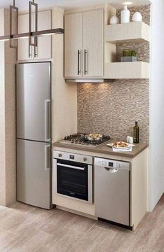 a kitchen with stainless steel appliances and white cabinets