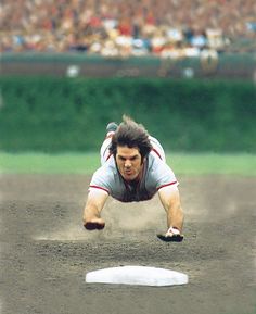 a baseball player dives to catch the ball