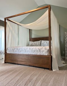 a canopy bed sitting in the middle of a bedroom