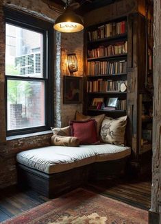 a room with a couch, bookshelf and window