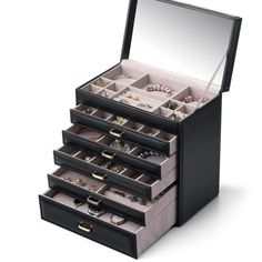 an open black jewelry box with five drawers