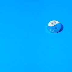 a small round object sitting on top of a blue surface