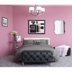 a bedroom with pink walls and grey bedding, chandelier and mirror on the wall