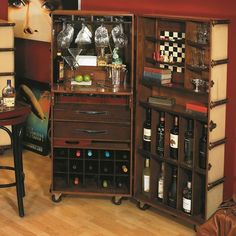 a wooden cabinet filled with lots of bottles and wine glasses on top of it's sides