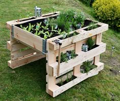 a table made out of wooden pallets filled with plants