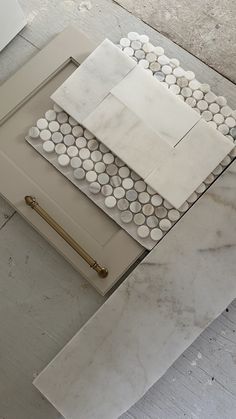 an old typewriter sitting on top of a marble table next to a white door