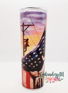 an american flag painted on the side of a metal cup with power lines in the background