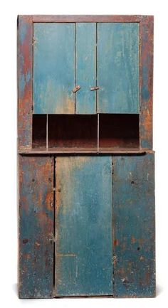 an old blue cabinet with two open doors