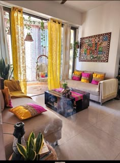 a living room filled with furniture and yellow drapes