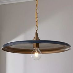 a light fixture hanging from a ceiling in a room with white walls and blue trim