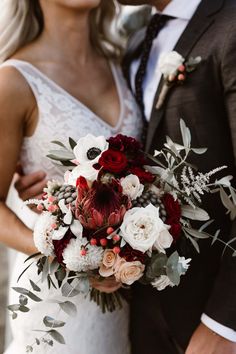 the bride and groom are holding their bouquets