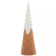 an ice cream cone with white frosting and sprinkles on the top